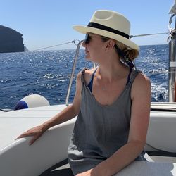 Young woman sitting on boat in sea