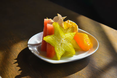 High angle view of fruits in plate on table