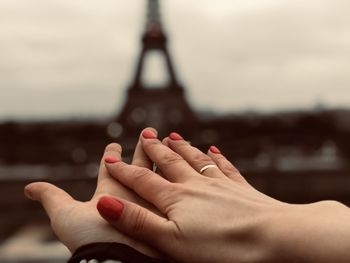 Close-up of man hand on finger against sky