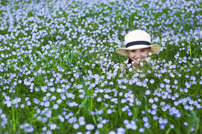 Portrait of young woman with flowers in park