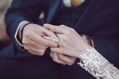 Midsection of couple holding hands