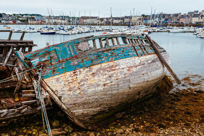 View of fishing boats moored at harbor