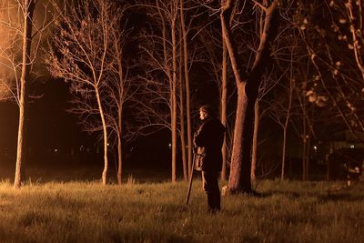 Evocative and suggestive view of a man standing on firing field at night