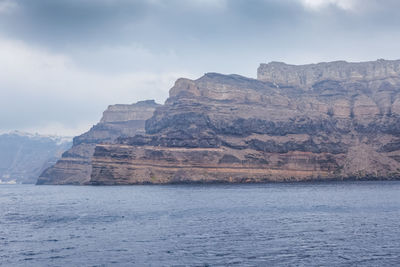 Scenic view of sea and mountains against sky