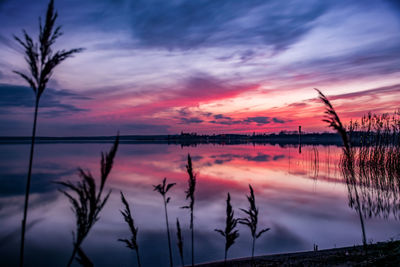 Scenic view of lake against romantic sky at sunset