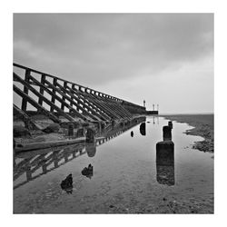 Bridge over sea against sky