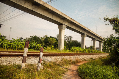 Bridge over field against sky