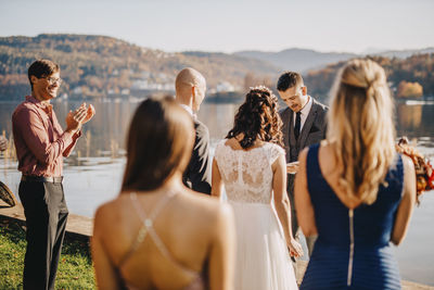 Wedding couple with guests at ceremony