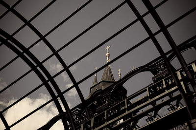 Low angle view of grid structure against sky