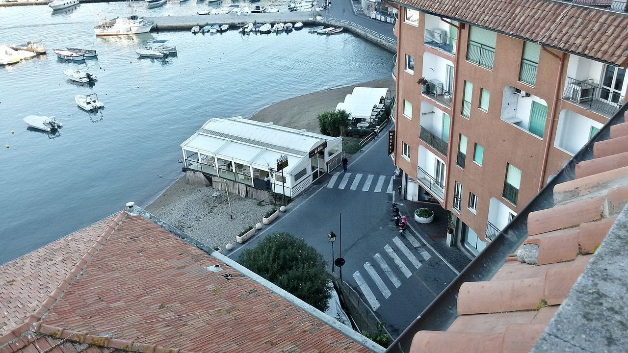 HIGH ANGLE VIEW OF RESIDENTIAL BUILDINGS AGAINST SKY