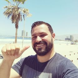 Portrait of young man against sky