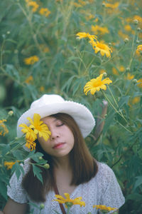 Beautiful woman with yellow flower