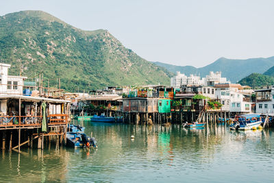 Scenic view of sea and mountains against clear sky