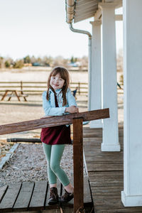 Full length of girl standing on seat