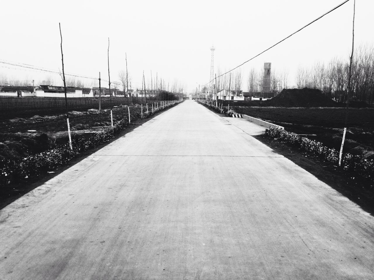 the way forward, diminishing perspective, clear sky, vanishing point, long, connection, surface level, transportation, sky, empty, copy space, railing, built structure, outdoors, fence, day, field, grass, no people, walkway