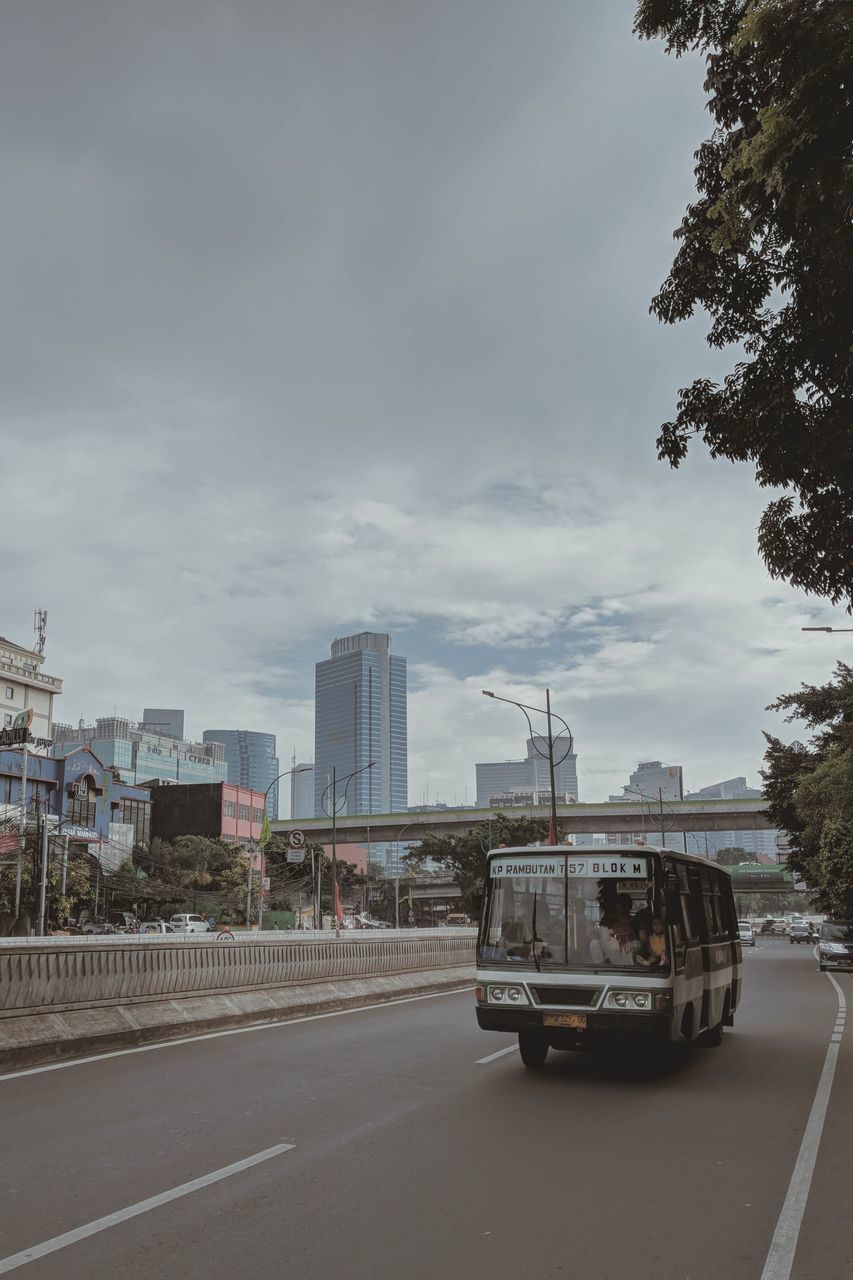 CARS ON ROAD AGAINST SKY