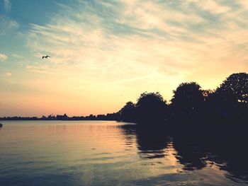 Scenic view of lake against sky during sunset