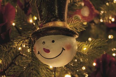 Close-up of christmas decoration hanging on tree at night