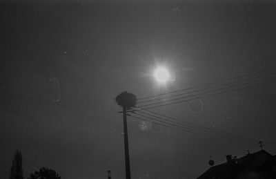 Low angle view of silhouette street light against sky at night