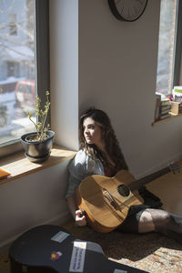 Young woman playing an acoustic guitar