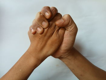 Close-up of human hand against white background