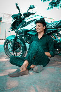 Portrait of a smiling man sitting outdoors