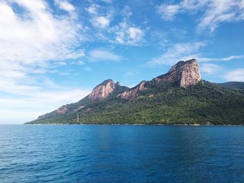 Scenic view of sea and mountains against sky