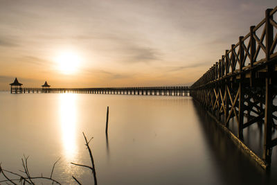 Silhouette bridge against sky during sunset