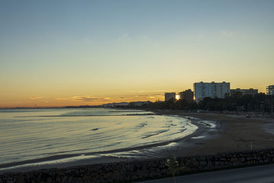 Scenic view of beach against sky during sunset