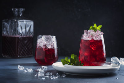 Close-up of drinks on table against black background