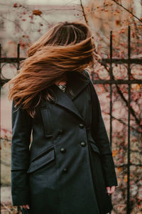 Rear view of woman standing on snow