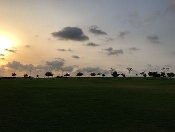 Scenic view of field against sky at sunset