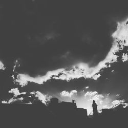 Low angle view of silhouette buildings against sky