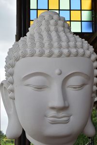 Close-up of buddha statue against temple