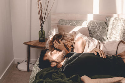 Couple relaxing on bed at home