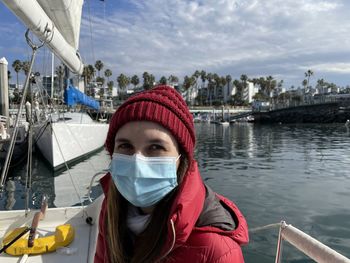 Portrait of woman wearing a mask against sky