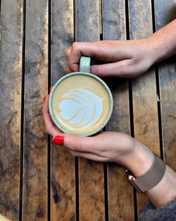 Hand holding coffee cup