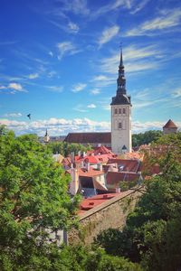 Panoramic view of buildings and trees against sky