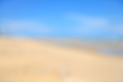 Defocused image of landscape against blue sky