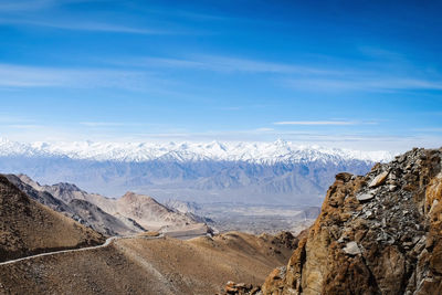 Panoramic view of snowcapped mountains against blue sky