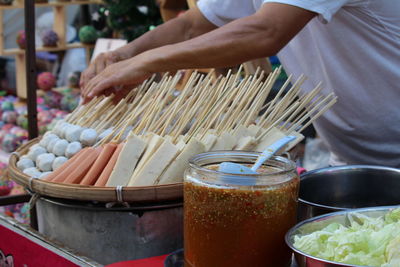 Midsection of man preparing food