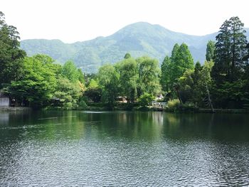 Scenic view of lake and mountains against clear sky