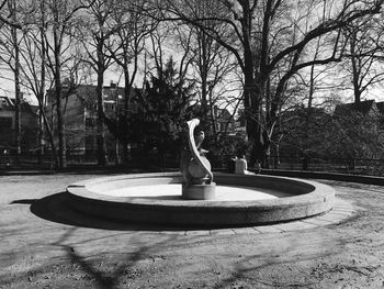 Playground by trees against sky