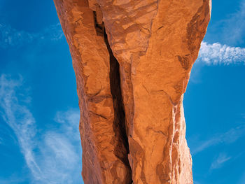 Low angle view of rock formation against blue sky