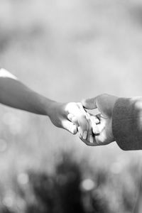 Close-up of couple hands against blurred background