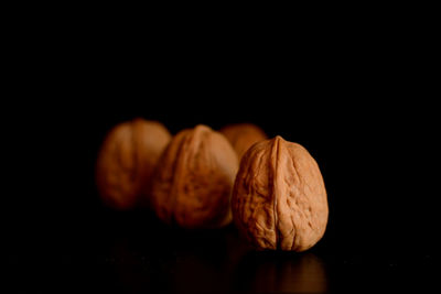 Close-up of bread on table against black background