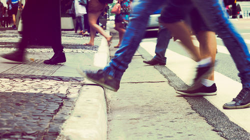 Low section of people walking on street