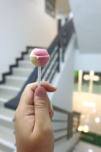 Close-up of hand holding lollypop