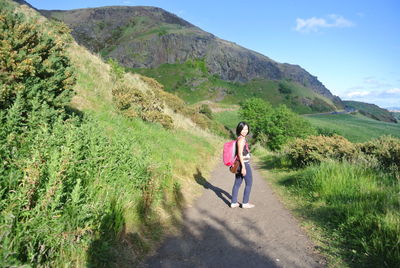 Full length of woman on mountains against sky