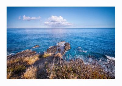 Scenic view of sea against blue sky